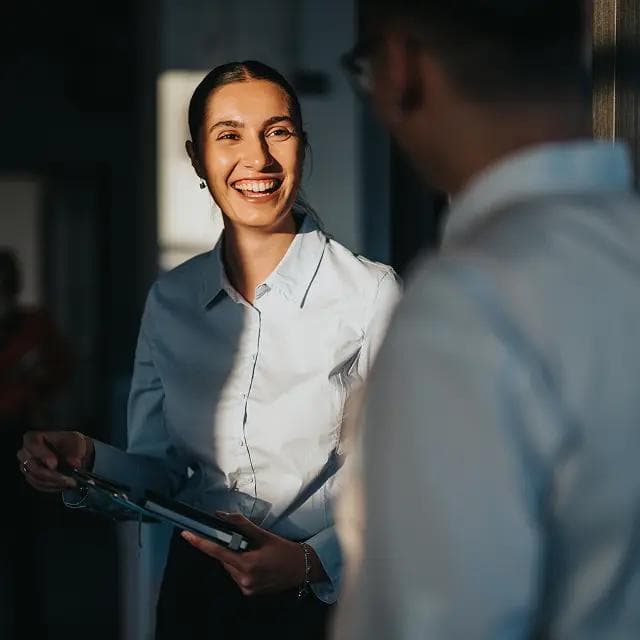 Woman smiling talking to a coworker